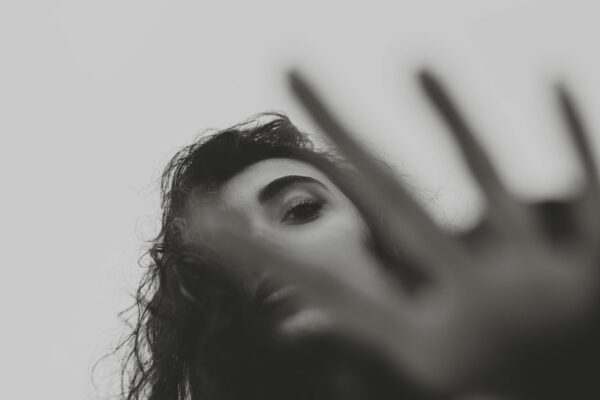 a black and white photo of a woman's face and hands